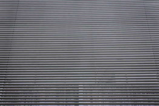 texture of steel ventilation grille on the wall of a building