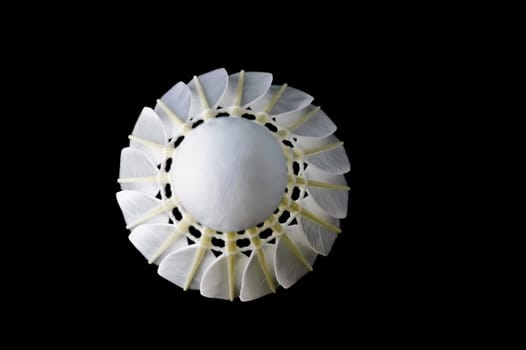 Top view of feather shuttlecock isolated on black background