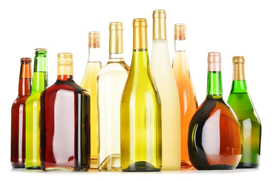 Bottles of assorted alcoholic beverages isolated on white background