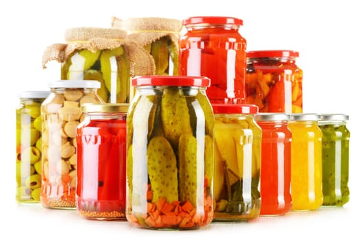 Composition with jars of pickled vegetables isolated on white. Marinated food