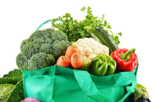 Shopping bag with variety of fresh organic vegetables isolated on white