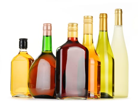 Bottles of assorted alcoholic beverages isolated on white background