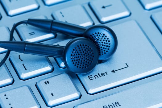 Headphones and computer keyboard, concept of digital music