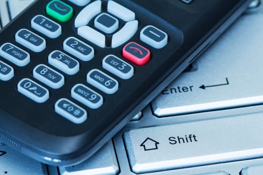 Mobility concept. Computer keyboard and mobile phone.