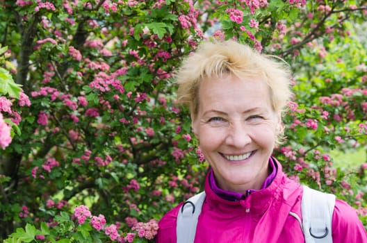 Portrait of a woman in a blossoming hawthorn