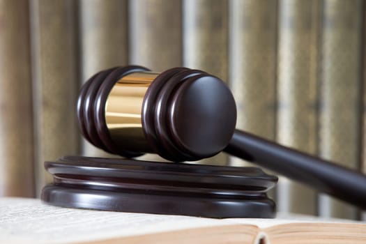 wooden gavel and books on wooden table