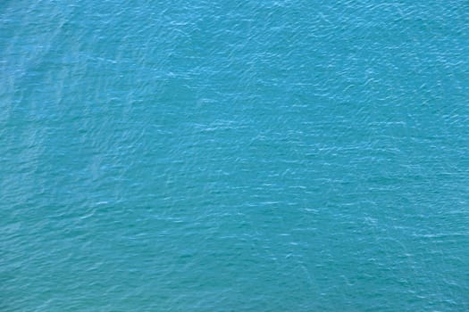 Blue water with sun reflections