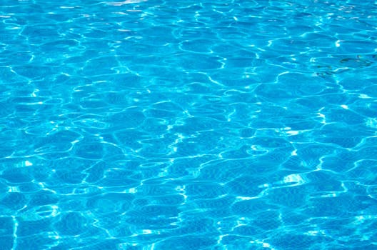 Blue pool water with sun reflections