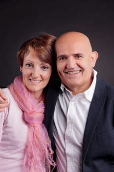 old couple loving each other smiling and looking at camera