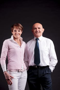 an elderly couple smiling to the camera