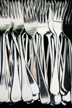 Closeup of bunch of metal silver colored eating forks
