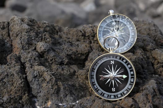 Orientation Concept - Analogic Compass Abandoned on the Rocks