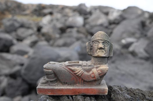 Ancient Maya Statue on the Rocks near the Ocean
