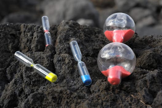 Time Concept - Hourglass Abandoned on the Volcanic Rocks