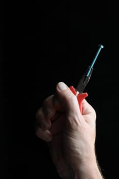 Pliers and a Hand on a Black Background