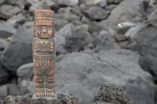 Ancient Maya Statue on the Rocks near Ocean