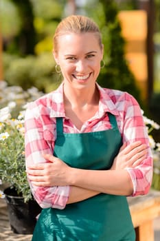 Garden center smiling woman worker wear apron portrait sunny day