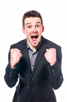young businessman in suit smiles at the camera in the camera and has both stretched by fists. Isolated on white