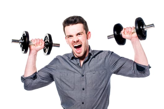 Young male businessman in light suit with power lifts a dumbbell and shows strength and determination, isolated against white background