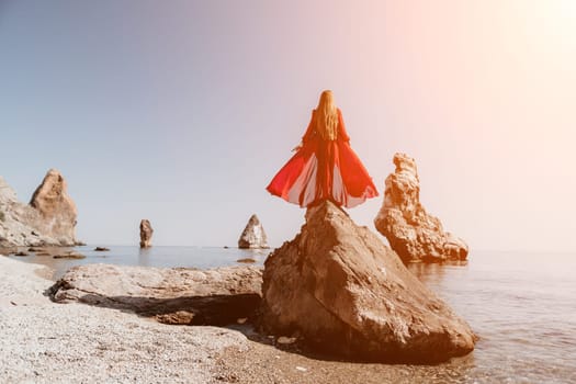 Woman travel sea. Happy tourist taking picture outdoors for memories. Woman traveler looks at the edge of the cliff on the sea bay of mountains, sharing travel adventure journey.