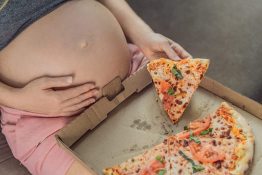 A pregnant woman enjoys a slice of pizza, savoring a moment of indulgence while satisfying her craving for a delightful, comforting treat. Excited Pregnant Young Lady Enjoying Pizza Holding Biting Tasty Slice Posing With Carton Box. Junk Food Lover Eating Italian Pizza. Unhealthy Nutrition Cheat Meal.