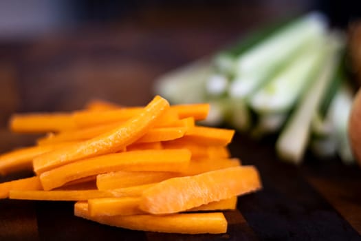 Chopped carrot on wooden board selective focus. Julienne Carrots On The Food Preparation Table.