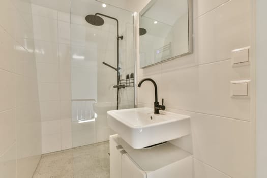 a white bathroom with a sink and mirror on the wall, in front of a walk - in shower stall