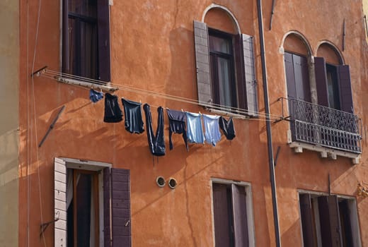 Gorgeous Venice. The narrow street channel. Picturesque laundry drying on clothesline