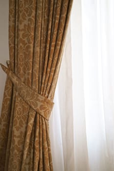 Beautiful brown curtains with a pattern. eautiful curtains that would be the perfect addition to any home.