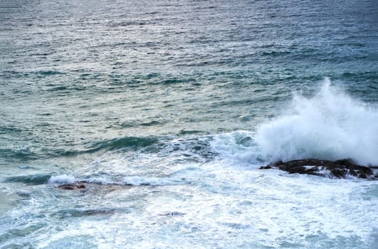 vertiginous, swirling foamy water waves photographed from above