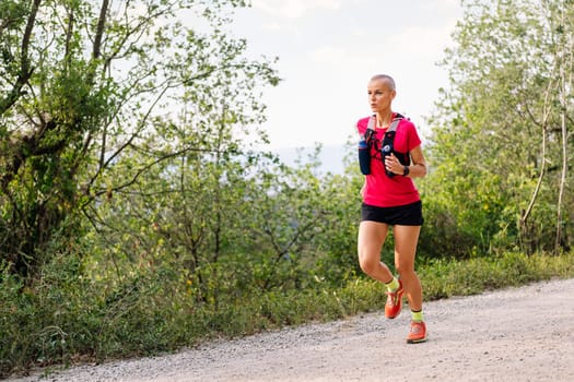 woman running in the countryside, concept of sport in nature and active lifestyle, copy space for text