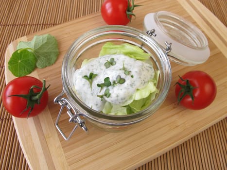 Salad in glass with yoghurt dressing and broccoli sprouts