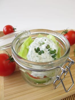 Salad in glass with yoghurt dressing and broccoli sprouts