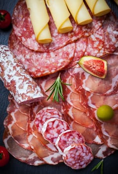 Antipasti and catering platter with different meat and cheese products