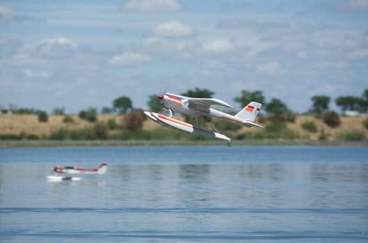 Radio controlled Hydroplane flying and sailing over the Guadiana river surface, Badajoz, Spain