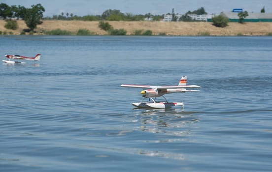 Radio controlled Hydroplane flying and sailing over the Guadiana river surface, Badajoz, Spain
