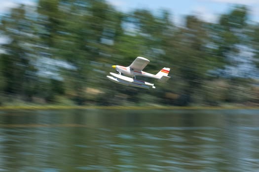Radio controlled Hydroplane flying  over the Guadiana river surface, Badajoz, Spain. The image shows motion blur