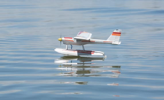 Radio controlled Hydroplane flying and sailing over the Guadiana river surface, Badajoz, Spain