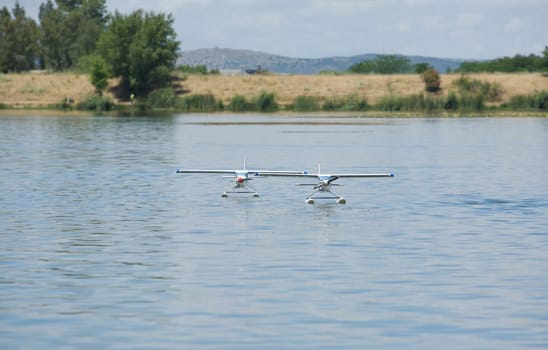 Radio controlled Hydroplane flying and sailing over the Guadiana river surface, Badajoz, Spain