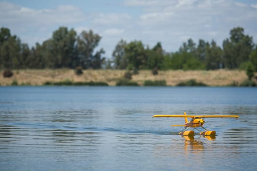 Radio controlled Hydroplane flying and sailing over the Guadiana river surface, Badajoz, Spain