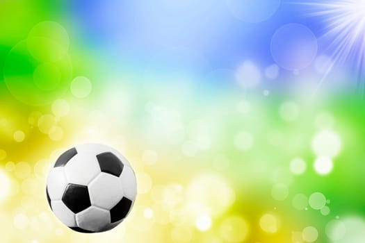 Soccer ball on blue, yellow and green background representing the colors of the Brazil flag