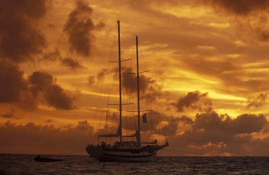 A sailing ship for cruises in the island world in the Northmale Atoll on the islands of the Maldives in the Indian Ocean.