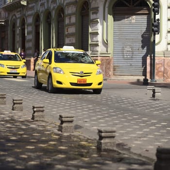 CUENCA,ECUADOR - FEBRUARY 13,2014: Taxi on the Mariscal Sucre Avenue on February 13,2014 in the city center of Cuenca,Ecuador