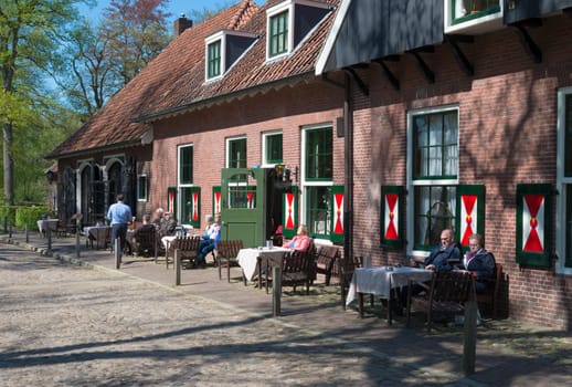 people drinking in front of a cozy restaurant in Denekamp, Netherlands