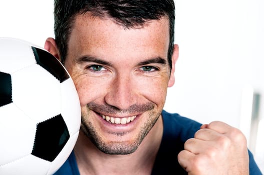 closeup of passionate soccer player with white and black balloon