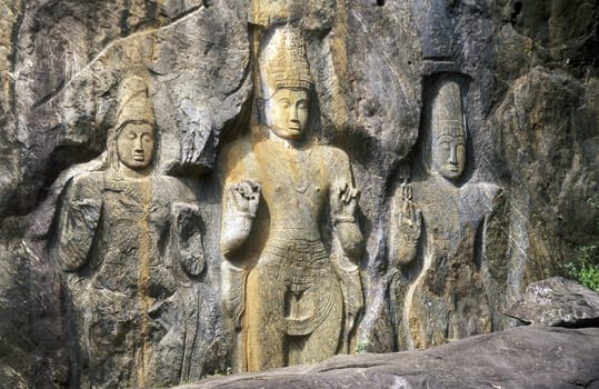 The rock Buddha statues at Buduruvagala in the south of the island of Sri Lanka in the Indian Ocean.