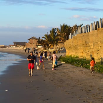 MANCORA,PERU - AUGUST 17,2013: Unidentified people on the sandy beach on August 17,2013 in Mancora,Peru. The small Northern Peruvian town of Mancora is a popular beach town and lives from tourism and fishing.