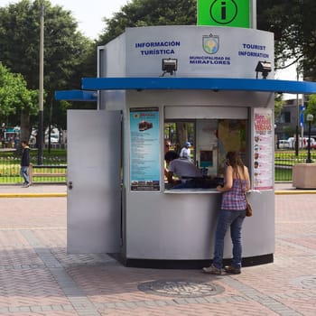 LIMA,PERU - FEBRUARY 11,2012: Unidentified people at the tourist information at the Kennedy Park in the district of Miraflores on February 11,2012 in Lima,Peru. Miraflores is the most touristy district of Lima,which has the most infrastructure for tourism.