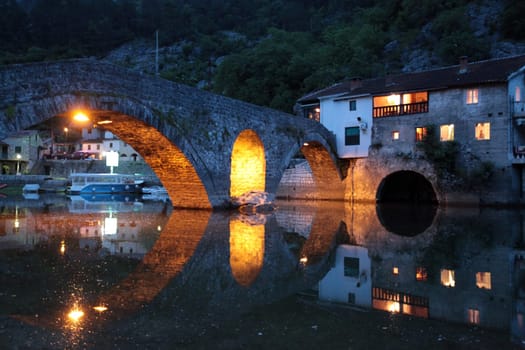 The landscape with the stone bridge of Rijeka Crnojevica with the river Rijeka Crnojevica at the western end of the Skadarsko Jezero lake or Skadar lake in Central Montenegro in Montenegro in the Balkans on the Mediterranean Sea in Europe.