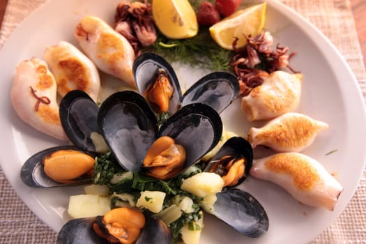 A seafood plate in a restaurant in the fishing village of Milocer near Sveti Stefan on the Mediterranean coast in Montenegro in the Balkans in Eastern Europe.